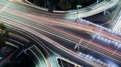 Highway outlined with neon multi-colored lines on the road.