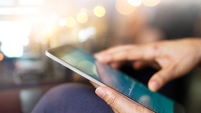 Closeup shot of a man's hands holding an ipad.