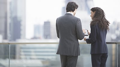 Two young business people working together on a rooftop